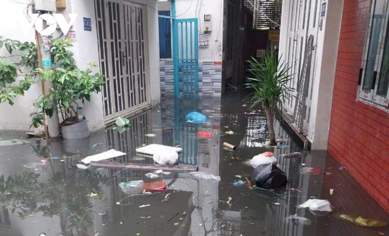 Người dân sử dụng bao cát để chắn nước mưa tràn vào nhà trong một con hẻm ở Hoàng Mai Hà Nội